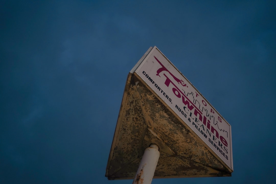 a-weathered-townline-sign-against-a-dark-sky-5qmmpkeayo0