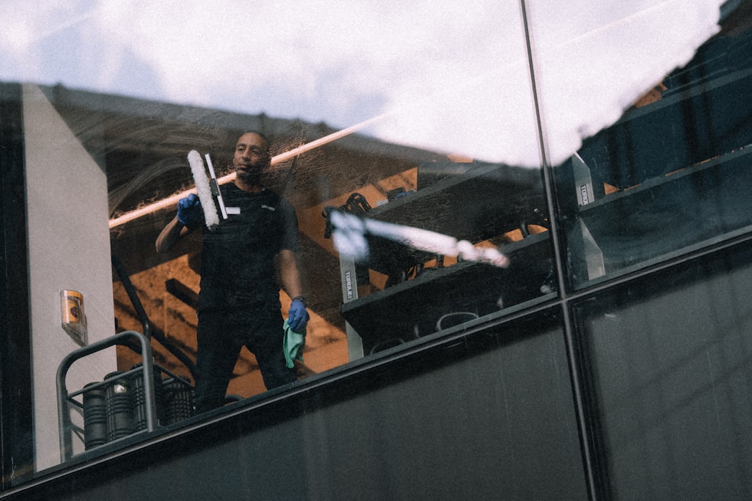 a-man-cleaning-windows-on-a-tall-building-zn6zqy6gvvm